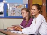A young teacher helping her student with a project on her laptop while smiling at the camera bespoke languages tuition (blt) Flat 3, 18 Cavendish Road 