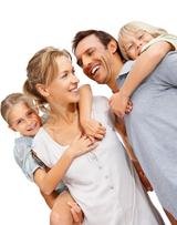 Portrait of a happy mature man and woman carrying kids on back at the beach NEWS Insurance Services, Inc 2072 Orchard Drive, Suite A 