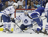 Toronto Maple Leafs goalie James Reimer (34) makes a save on a shot by Tampa Bay Lightning defenseman Eric Brewer (2) as Maple Leaf's defenseman Jake Gardiner (51) looks on during the first period of an NHL hockey game Tuesday, April 8, 2014, in Tampa, Fl