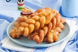 Koeksisters are a sticky, crunchy donut sweet treat that is popular across South Africa. More specifically, they have a crunchy outside crust with a sticky, almost liquid syrup sensation in the centre.

https://www.biltongplus.co.nz/koeksisters/, Biltong Plus, Wellsford