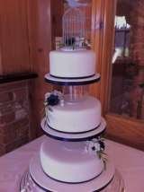 Blue and white anemones  with vintage birdcage from Â£410 Sharon Lord Cakes Fiddlers Field Croydon Road 