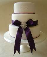 3 tier with satin ribbon and brooch from Â£325 Sharon Lord Cakes Fiddlers Field Croydon Road 