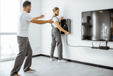 Two professional workmen installing luxury audio system in the white living room, NYC TV Mounting & Home Theatre Installers, New York