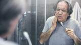 A picture of a senior experiencing tooth pain while brushing his teeth
, Dentistry at The Grove, Burlington