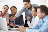 Business team discussing project with man pointing at the laptop, Webespire Consulting, Noida