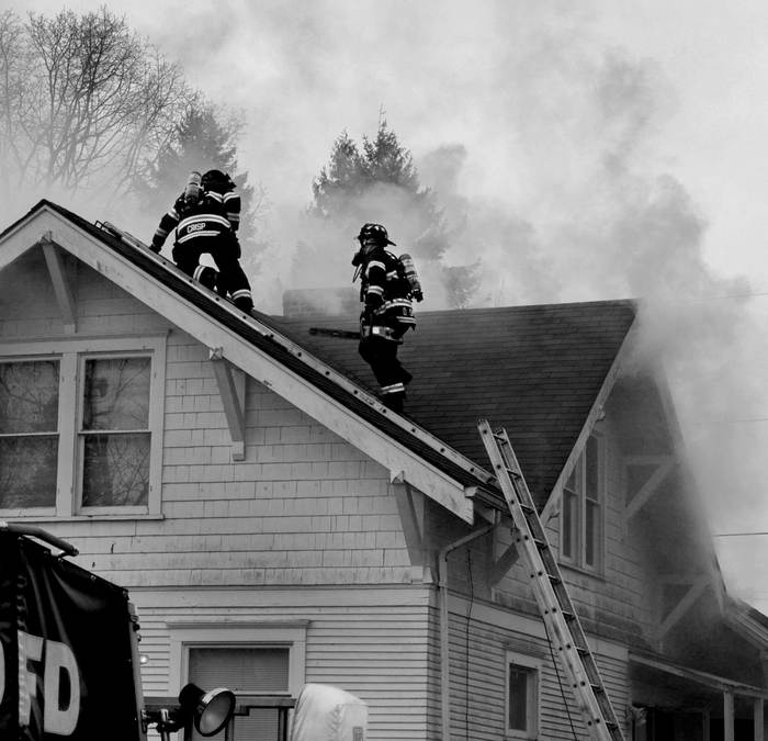 Firemen at house with smoke and fire damage Fire and Smoke Damage Insurance Claims of ClaimsMate 803 Whitecap Dr - Photo 1 of 7