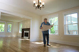 Contractor looking at blueprint , Cloud Free Windows, Seaford