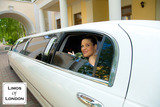 Photo of young happy woman looking out of white limousine window with arc on the background, Limos Of London, London