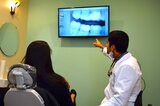 Dallas dentist Dr. Ron Hassanzadeh explaining dental implants Seven Hills Dentistry 1305 Cedarcrest Rd #115 