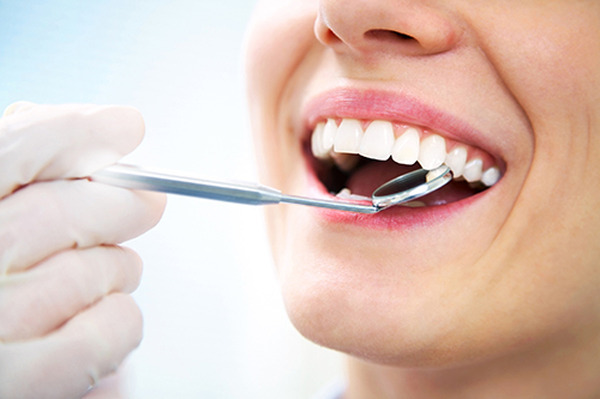 Close-up of young female having her teeth examinated Profile Photos of Josey Lane Dentistry 2440 N Josey Ln #102 - Photo 6 of 12