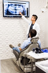 Cypress dentist Dr. Patrick Vuong, DMD talking to dental implant patient at Smile Avenue Family Dentistry of Cypress Smile Avenue Family Dentistry of Cypress 9212 Fry Rd #120 
