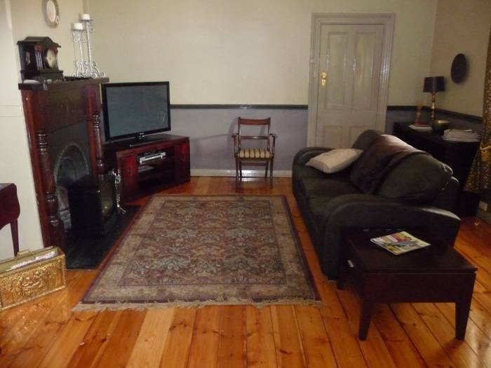 Lounge with satellite TV & leather sofa bed. Profile Photos of Country bakehouse Accommodation Main Street - Photo 2 of 11