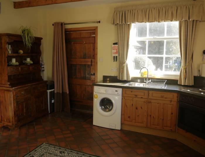 Kitchen area in  Well Cottage facing the door Internal photos of holiday properties. of Manston Court Accommodations Manston Court, Manston Court Road, Manston, - Photo 9 of 18
