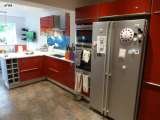 After - high gloss red units with aluminum carcass sides. Blue glass splash backs and Okite white quartz worktop.  Intoto Kitchens Wokingham 23 Peach Street 