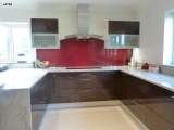 After - Ebony high gloss doors with granite worktops and red rainbow sparkle glass splash back. Intoto Kitchens Wokingham 23 Peach Street 
