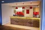 After - Wokingham Theatre. Oak effect units with Silestone worktop and red splash back., Intoto Kitchens Wokingham, Wokingham