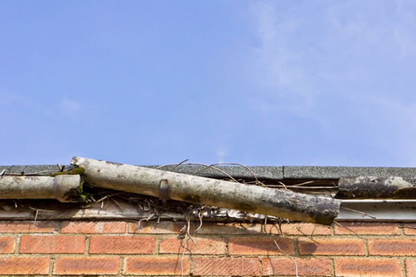 A broken plastic gutter on the roof of a house Profile Photos of Cypress Water Fire Smoke Damage Restoration Services 17515 Spring Cypress Rd - Photo 4 of 4