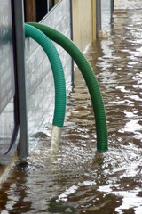 Pipes pumping water from flooded property in York Cypress Water Fire Smoke Damage Restoration Services 17515 Spring Cypress Rd 