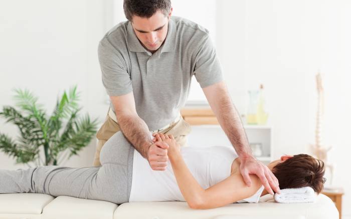 A masseur is stretching a woman's arm Profile Photos of Massage Specialists Mobile Massage - Photo 1 of 23