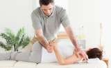 A masseur is stretching a woman's arm Massage Specialists Mobile Massage 