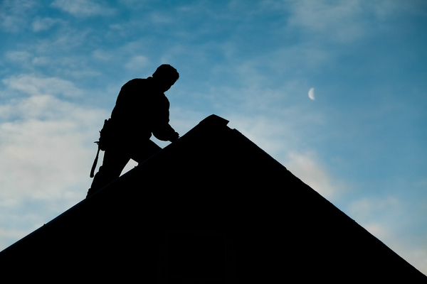 Contractor in Silhouette working on a Roof Top with blue Sky in Background Pricelists of Kcity Best Roofing 520 West 103rd Street # 110 - Photo 2 of 2 Contractor in Silhouette working on a Roof Top with blue Sky in Background Pricelists of Kcity Best Roofing 520 West 103rd Street # 110 - Photo 2 of 2