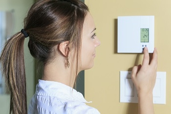 A woman set the thermostat at house. Profile Photos of Betco Heating and Air Conditioning 14391 Spring Hill Drive Ste 105 - Photo 4 of 5