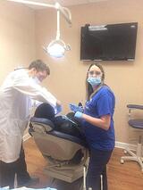 Dr. Justin Neibauer performing root canal procedure at his dental clinic in Fredericksburg, VA 22407 Freedom Family Dentistry 10039 Patriot Hwy 