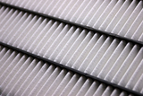 Close-up of the elements of a clean car air filter; dynamic shot using diagonal lines.