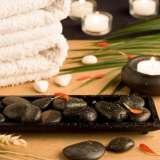 Spa setting with white towels, pebbles, candles and palm leaf, Acupuncture & Alternative Health Care Concepts,Inc., Toluca Lake