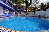 Enjoy a refreshing drink in the Goan summer at the poolside deck of the Deluxe Heritage, Heritage Resort, Siolim