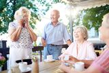 Laughing seniors spending leisure in outdoor cafe Heatherwood Senior Living 5277 W. Kootenai St 