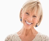 Close-up portrait of happy mature woman over white background, Portage Park Dentist, Chicago
