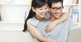happy young couple using laptop at home, 12 Month Payday Loans, Slough