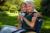 Disabled woman in wheelchair and nurse holding thumbs up A-1 Home Care Agency 2400 W. Coast Hwy 