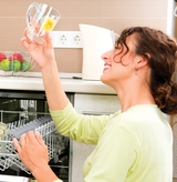 Dishwasher. Happy Young woman in the Kitchen doing Housework. Dishwasher Machine, dishwashing. Wash-up. Smiling Girl using dishwasher machine, South Gate Appliance Repair Express, South Gate