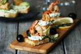 Appetizer canape with shrimp and olives on cutting board on table close up Brooke DuprÃ© Events - Event Planner 5H, Stamford Works, 3 Gillett St 