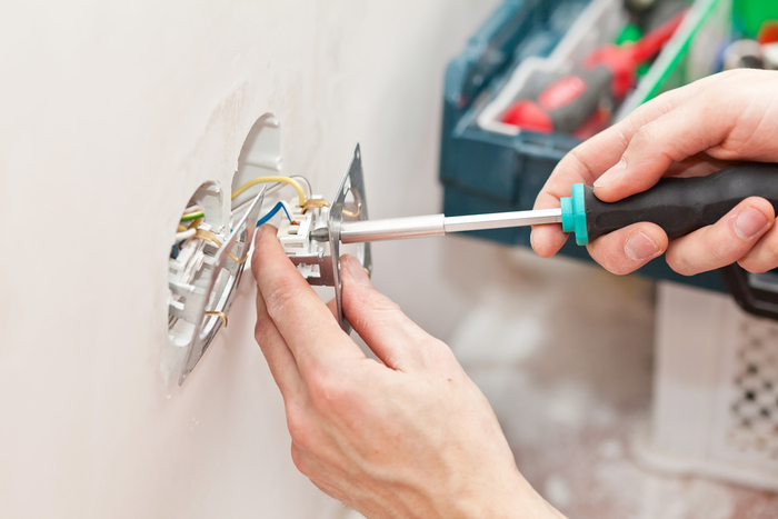 The hands of an electrician  New Album of AAA Electric Company Inc 6525 Gunpark Dr. - Photo 4 of 9