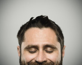 Portrait of a real caucasian young man with happy expression and eyes closed. Brown eyes and hair with beard. 35 years old north american. Horizontal color image from a dslr camera in studio., I.ROC Wellbeing, Edinburgh