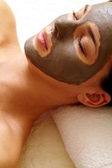 Relaxed girl with clay or mud mask on face for pore cleaning, Ruby's Hair & Beauty Salon, London