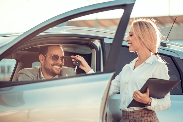 Car dealership.Young man receiving car key from saleswoman. New Album of House Of Cars (Macleod Tr) 3909 MacLeod Trail S - Photo 4 of 10 Car dealership.Young man receiving car key from saleswoman. New Album of House Of Cars (Macleod Tr) 3909 MacLeod Trail S - Photo 4 of 10