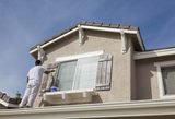 Busy House Painter Painting the Trim And Shutters of A Home., Akron Painters Painting Company, Akron