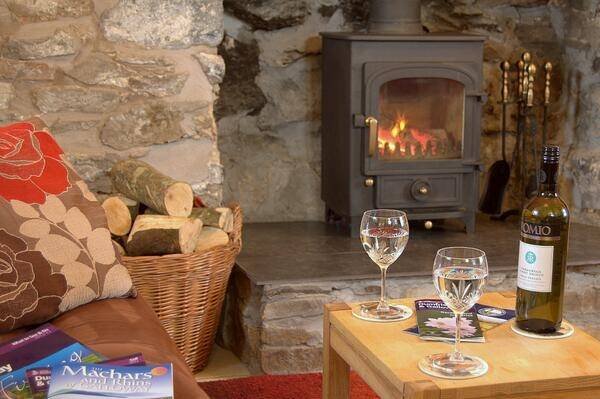 Auld Smiddy Log Fire in Sittingroom Profile Photos of East Muntloch Croft Bed & Breakfast and Auld Smiddy & Glen Auchie Holiday Cottages East Muntlloch Croft B & B, Cairngaan Road, - Photo 4 of 14