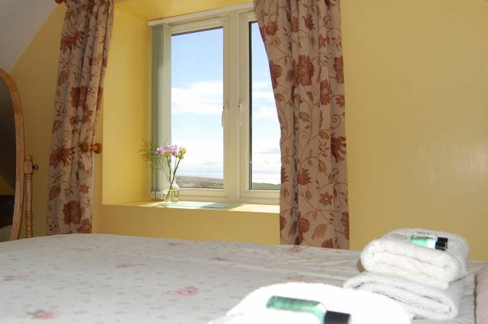 Bedroom view to the Mull of Galloway lighthouse and the sea. Profile Photos of East Muntloch Croft Bed & Breakfast and Auld Smiddy & Glen Auchie Holiday Cottages East Muntlloch Croft B & B, Cairngaan Road, - Photo 8 of 14 Bedroom view to the Mull of Galloway lighthouse and the sea. Profile Photos of East Muntloch Croft Bed & Breakfast and Auld Smiddy & Glen Auchie Holiday Cottages East Muntlloch Croft B & B, Cairngaan Road, - Photo 8 of 14