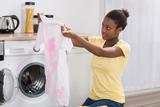 Young African Woman Looking At Stained Cloth In Kitchen, Reliable Appliance Repair Solutions, Downers Grove