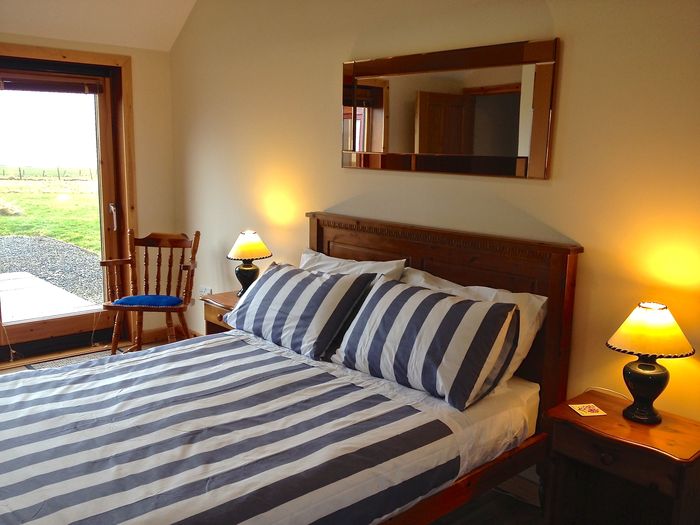 Double bedroom in croft with sliding glass doors to patio and views of Scapa Flow and the Hills of Hoy Croft House sleeping 8 in 2 doubles and 2 bunk bed of Buxa Farm Chalets & Croft House A964 - Photo 9 of 18 Double bedroom in croft with sliding glass doors to patio and views of Scapa Flow and the Hills of Hoy Croft House sleeping 8 in 2 doubles and 2 bunk bed of Buxa Farm Chalets & Croft House A964 - Photo 9 of 18