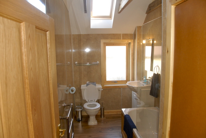 Family bathroom in croft with shower over bath and lots of fluffy towels Croft House sleeping 8 in 2 doubles and 2 bunk bed of Buxa Farm Chalets & Croft House A964 - Photo 11 of 18
