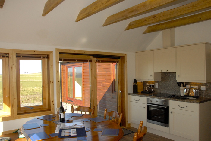 Kitchen in the croft with all the modern cons-fridge/freezer, fan oven, dishwasher, clothes washer, etc.  Croft House sleeping 8 in 2 doubles and 2 bunk bed of Buxa Farm Chalets & Croft House A964 - Photo 5 of 18