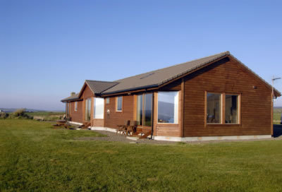 Back view of the chalets, sliding doors lead to patio area with picnic table 3 chalets sleeping 4 each in king and/or twin beds of Buxa Farm Chalets & Croft House A964 - Photo 4 of 16 Back view of the chalets, sliding doors lead to patio area with picnic table 3 chalets sleeping 4 each in king and/or twin beds of Buxa Farm Chalets & Croft House A964 - Photo 4 of 16