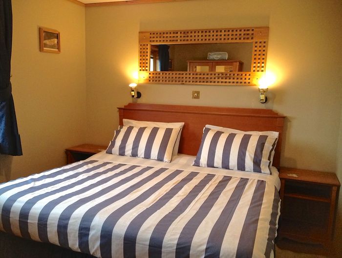 King size bed can be split into twins. 3 chalets sleeping 4 each in king and/or twin beds of Buxa Farm Chalets & Croft House A964 - Photo 12 of 16