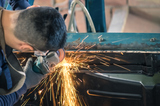 Young man mechanical worker repairing an old vintage car body in messy garage - Safety at work with protection wear, Marquis Auto Body Repair, Pembroke Park